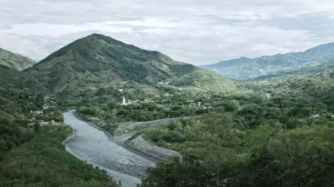 Panoramic view of small town in Colombia with river, mountains and forest  Stock Footage 153809995