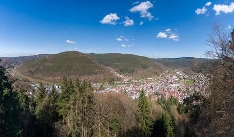 Panoramic View Of A Small Town In A Forested Valley Surrounded By Rolling Hills Stock Photos