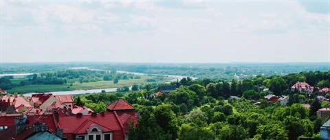 Panoramic view of a small town with red roofs, green trees and a winding river Stock Footage 319556214