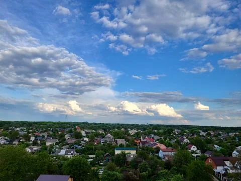 Panoramic View of Small Town Under Dramatic Blue Sky with Clouds Stock Photos