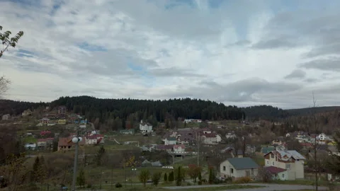 Panoramic view on small village between mountains and forest. Living in countrys 스톡 동영상 143141387