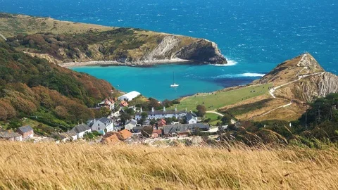 Panoramic view of a small village built near a bay on the jurassic coast Stock Footage 124908025