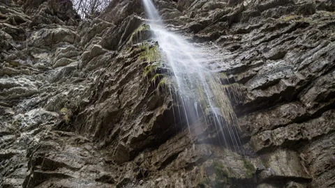 Panoramic view of a small waterfall on a large rock 動画素材 150013025