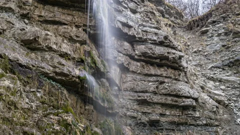 Panoramic view of a small waterfall on a large rock 動画素材 183263864