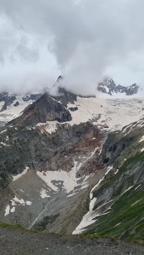 A panoramic view of the snow-capped Alps, during a hike on the Tour du Mont Blan Stock Footage 283928675