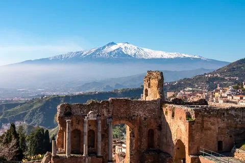 Panoramic view of snow capped Mount Etna volcano on a sunny day seen from a.. Stock Photos