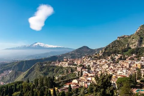 Panoramic view on snow capped Mount Etna volcano on a sunny day seen from a.. Stock Photos