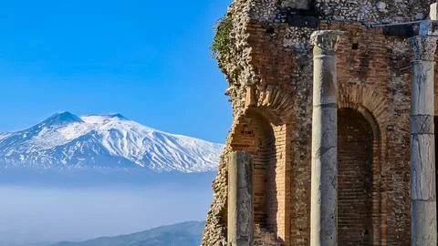 Panoramic view of snow capped Mount Etna volcano on a sunny day seen from t.. Stock Photos