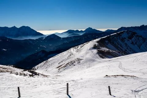 Panoramic view on snow capped mountain peaks of Karawanks in Carinthia, Aus.. Stock Photos