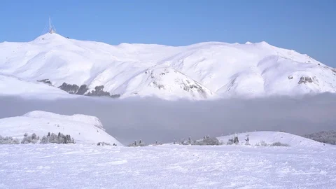 Panoramic view of the snow-capped mountains above the clouds Stock Footage 71837020