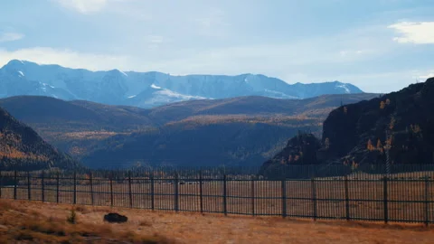 Panoramic View of Snow-Capped Mountains and Autumn Forest Stock Footage 312276530