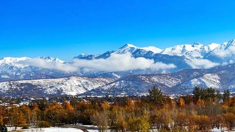 Panoramic view of snow-capped mountains with clouds Stock Photos