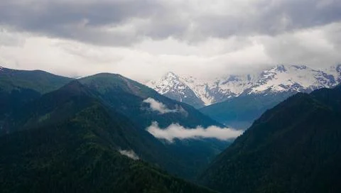 A panoramic view on the snow-capped peaks. Greater Caucasus Mountain Range Stock Photos