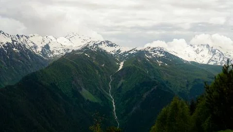 A panoramic view on the snow-capped peaks. Greater Caucasus Mountain Range Stock Photos