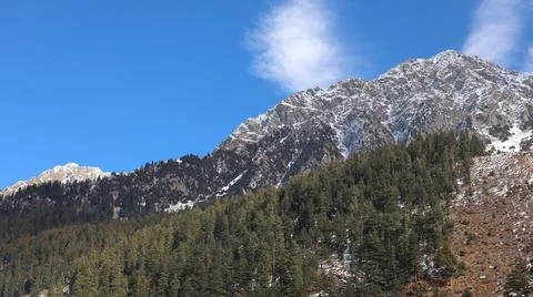 Panoramic View of Snow-Capped Peaks and Evergreen Forests in Kalam, Pakistan Stock Photos