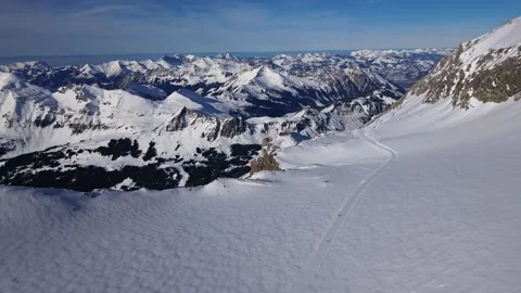 Panoramic view of the snow-covered Alpine mountains on a sunny. Stock Footage 303444949