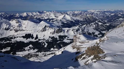 Panoramic view of the snow-covered Alpine mountains on a sunny. Stock Footage 303445356