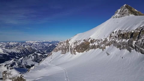 Panoramic view of the snow-covered Alpine mountains on a sunny. Stock Footage 303445465