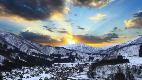 Panoramic View of Snow-Covered Mountain Range at Sunset 動画素材 310818031