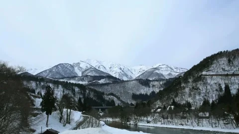 Panoramic View of Snow-Covered Mountain Range in Winter 動画素材 311529192