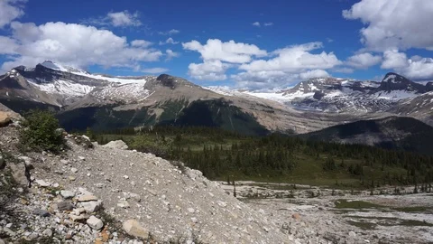 Panoramic view of snow-covered mountains, forest and rocky landscape 動画素材 123848857