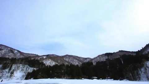 Panoramic View of Snow-Covered Mountains and Frozen Lake in Winter Stock Footage 311587233