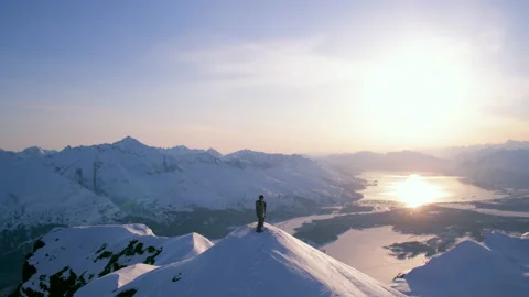 A panoramic view of a snowboarder on top of a mountain in Valdez, Alaska Video stock 230799455