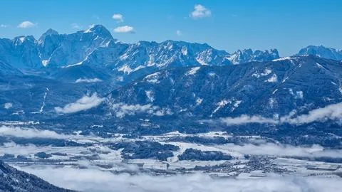 Panoramic view of snowcapped mountain summit Mangart and Jalovec in Julian .. Stock Photos