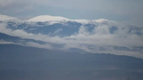 Panoramic view of snowcapped mountains and clouds in a tranquil landscape Stock Footage 309885745