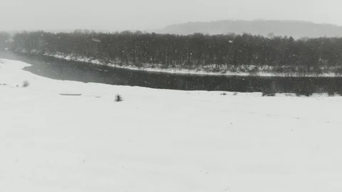 Panoramic view of snowing river and forest planting Stock Footage 120305645