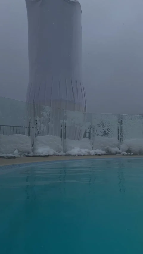 Panoramic view of spa resort hot pool at snowing day Stock Footage 246304761