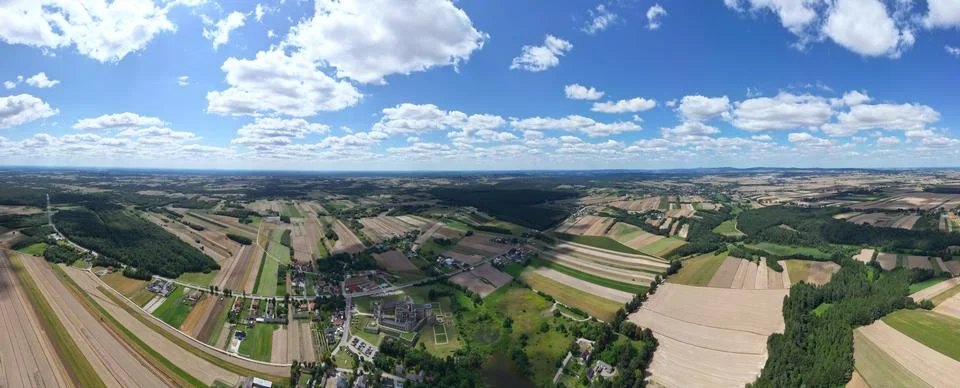 A Panoramic View of a Spacious Meadow with a Winding Road, Offering Serene .. Stock Photos