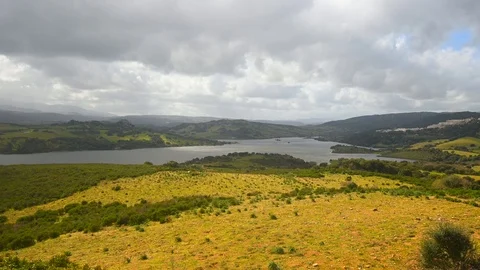 Panoramic view of a spring pasture and lake in the background Stock Footage 104875946