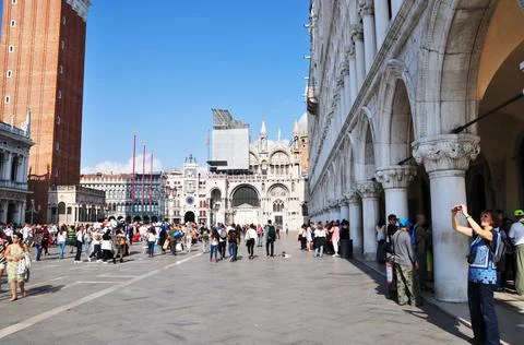 Panoramic view of St. Mark's Square. Tourists on the square see the sights. Stock Photos