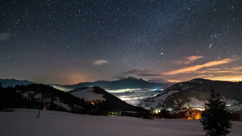 Panoramic view of starry night sky with stars and clouds in winter mountains Stock Footage 125318339