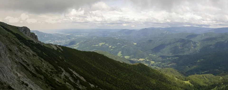 Panoramic View from a Steep Alpine Mountain Slope across Forested Valleys a.. Stock-Fotos