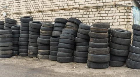 Panoramic view of storage of discarded old car tires outdoors, showcasing a.. Stock Photos