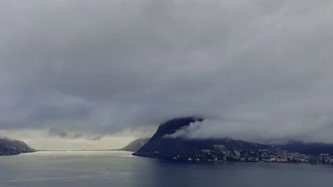 Panoramic View with Storm Clouds over City of Lugano and Lake with Mountain Stock Footage 224347117
