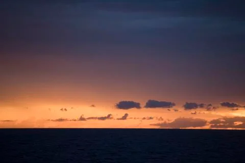 Panoramic view of a sunset over the ocean Stock Photos