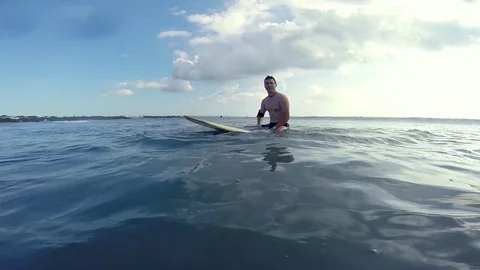 Panoramic view of surfer swimming on surf board and waving. Stock Footage 80245254