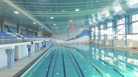 Panoramic view of swimming pool HD video. Indoor empty closed pool interior Stock Footage 72388754