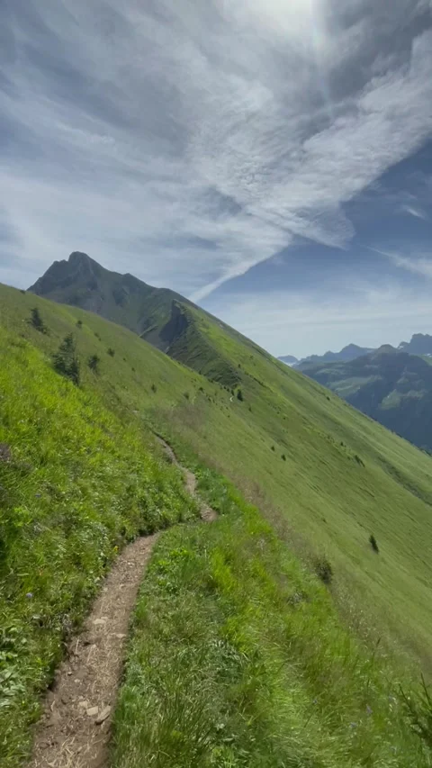 Panoramic view of the Swiss Alps with green mountain ridge and blue sky Stock Footage 341439221