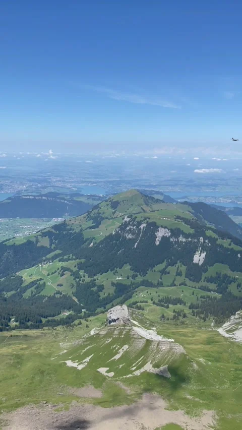 Panoramic view of the Swiss Alps with green mountain ridge and blue sky Stock Footage 341952261
