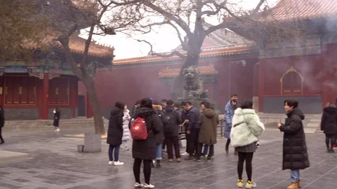 A panoramic view of temple full of asian people who burn incences Stock Footage 125275985