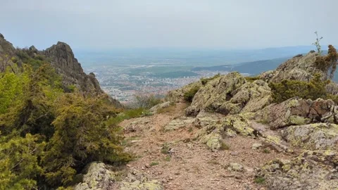Panoramic view from the top of the mountain and a man walking to the top with a  Stock Footage 242279878