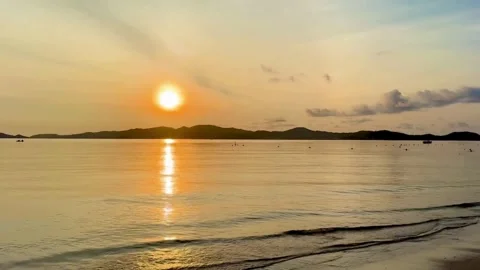 Panoramic view of tourists swimming under the beautiful sunrise light Stock Footage 328934441