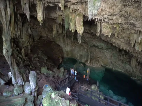 Panoramic view of tourists in the underground cave and lake with chrystal Stock Footage 71543063