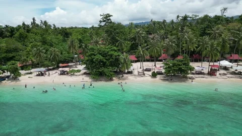 Panoramic view of a tranquil beach resort with clear water, white sand and trees Stock Footage 227986621