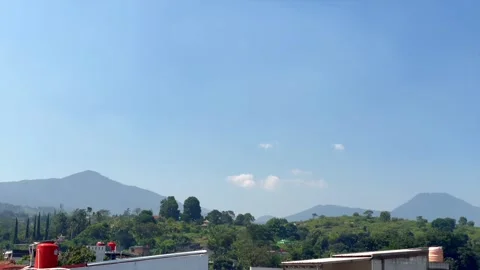 Panoramic view of tropical mountains under clear blue sky Vidéo 338170781