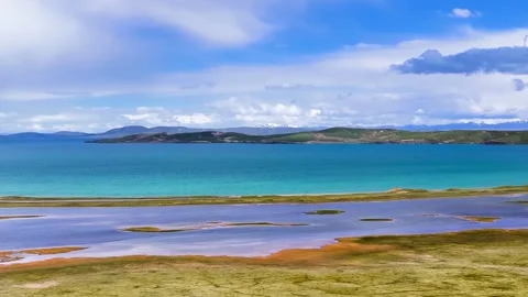 Panoramic View of Turquoise Lake and Snow Capped Mountains in Tibet China Video stock 346986091